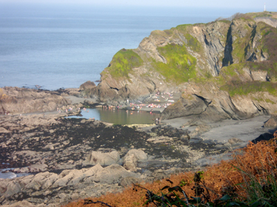 Bathers enjoying the autumn sunshine, September 2011, at Tunnels beach. Photograph taken from the coastal path above the beach.